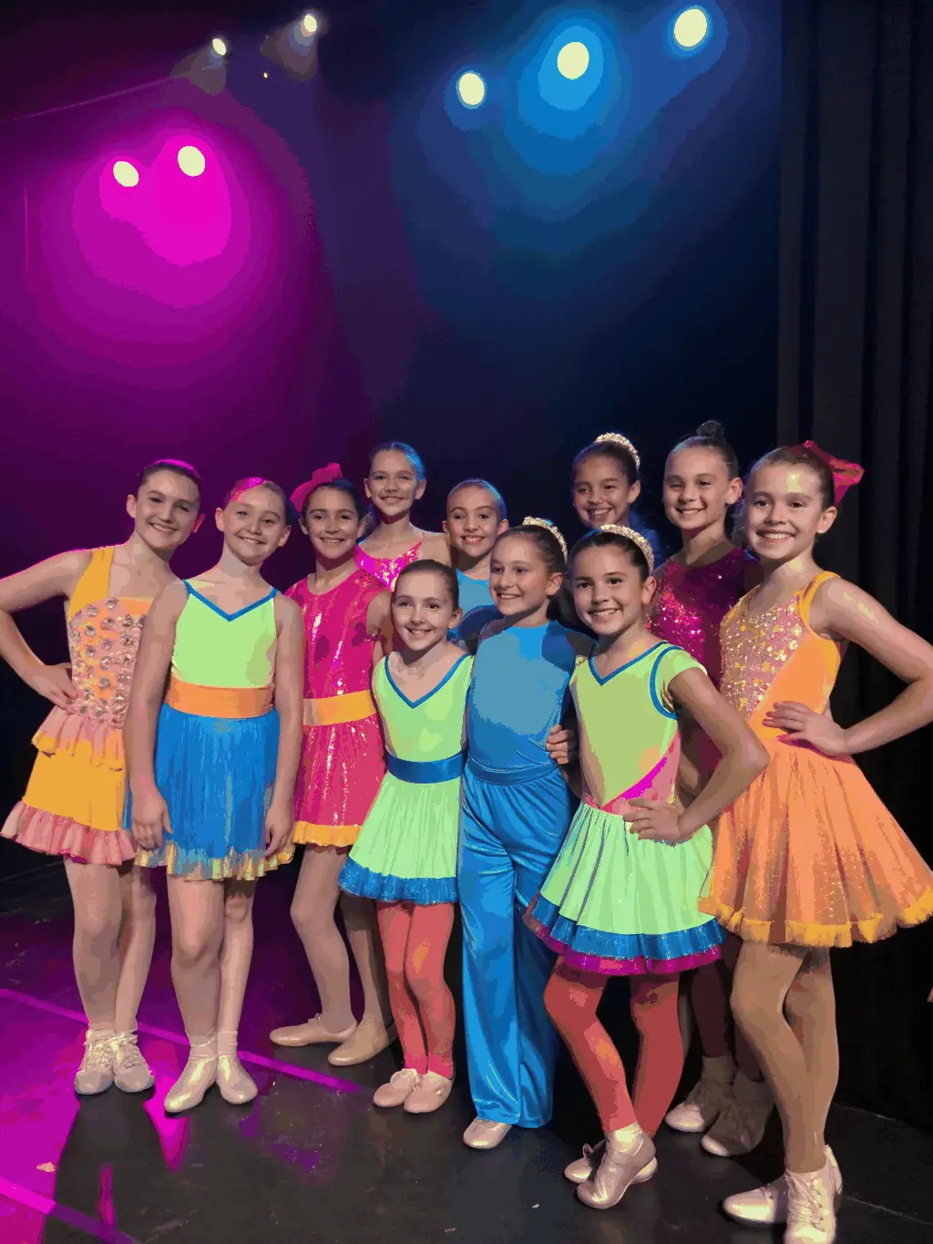 A group of children participating in a cultural workshop with colorful costumes and props, highlighting the integration of twirling baton with cultural activities.